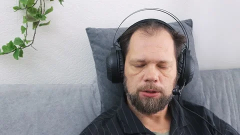 Remote work from home in a call center, a man in a headset working with a laptop Vídeo Stock 212076486