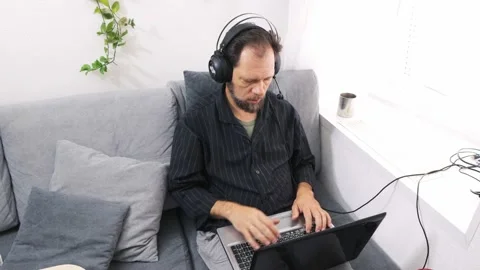 Remote work from home in a call center, a man in a headset working with a laptop Vídeo Stock 212079073