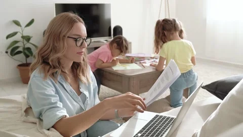 Remote work from home during covid 19 outbreak, young mother working on laptop Stock Footage 153385141