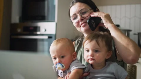 Remote work at home at table with laptop. upbringing of toddlers. Mom with Video stock 249926851
