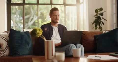 Remote work from home, thinking and man on sofa, laptop and problem solving with Stock Footage 310485852