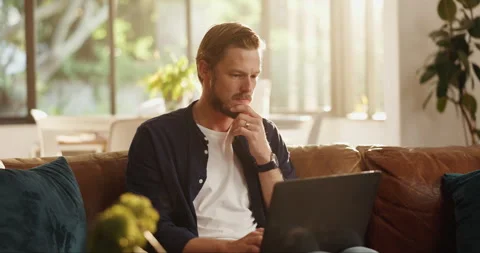 Remote work from home, thinking or man on couch, laptop or problem solving with Stock Footage 310354229