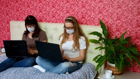 Remote work from home. Two Caucasian women a young blonde and an adult in a Stock Footage 128166326