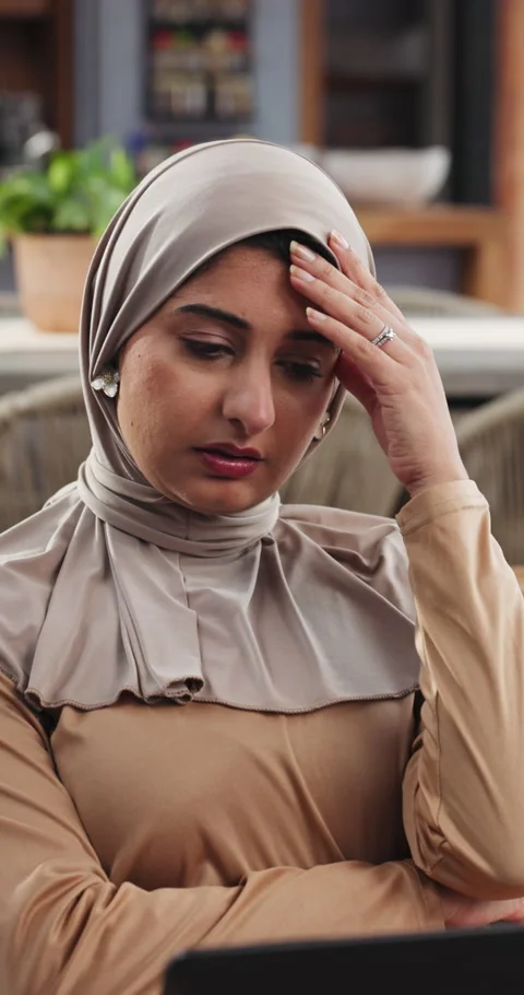 Remote work, laptop and Muslim woman on sofa with stress for thinking, mistake Stock Footage 329377482