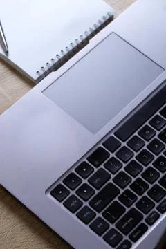 Remote work laptop notepad on the table Stock Photos