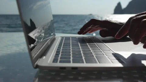 Remote work, laptop, ocean, hands typing by infinity pool overlooking the sea Stock Footage 320826440
