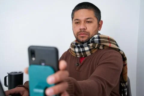 Remote Work: Man Using Phone for Tasks Stock Photos