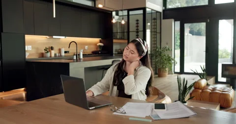 Remote work, neck pain and woman in kitchen, laptop for online article and Stock Footage 336659030