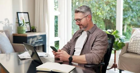Remote work, online and happy man with phone in home office, bookkeeping or Stock Photos