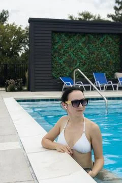 Remote work by the pool during a warm afternoon with a clear sky and a gree.. Stock Photos