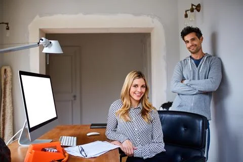 Remote work, portrait and happy couple with computer screen in home office Stock Photos