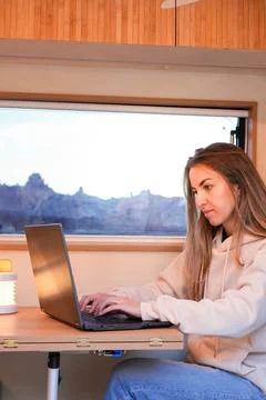 Remote Work on the Road: Digital Nomad in a Van at Sunset Stock Photos