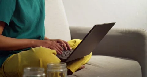 Remote work routine individual typing laptop at home comfortable setting casual Stock Footage 336633278