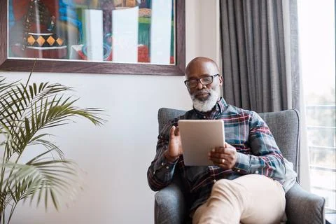 Remote work, scroll and man with tablet in lounge, email marketing and rese.. Stock-Fotos