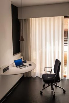 Remote Work Setup with Laptop and Desk in Modern Hotel Room Interior.. Stock Photos