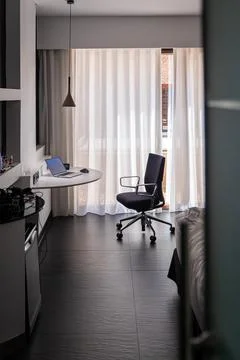 Remote Work Setup with Laptop and Desk in Modern Hotel Room Interior.. Stock Photos