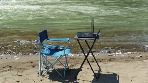 Remote Work Setup with Laptop on Folding Table by River Beach. Stock Footage 333863815