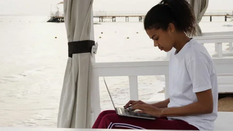 Remote work. Side view of concentrated young woman working on laptop while Stock Footage 149435327