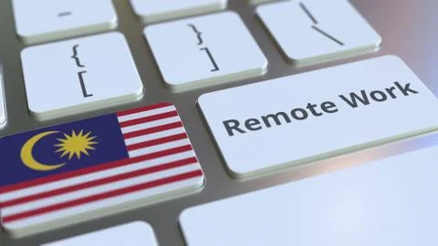 Remote Work text and flag of Malaysia on the computer keyboard. Telecommuting or Illustrazione stock