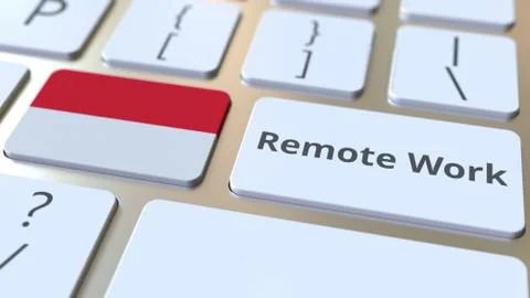 Remote Work text and flag of Indonesia on the computer keyboard. Telecommuting Illustrazione stock