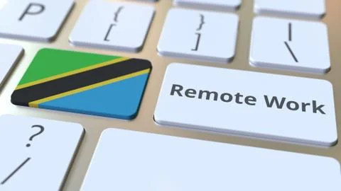Remote Work text and flag of Tanzania on the computer keyboard. Telecommuting or 스톡 일러스트