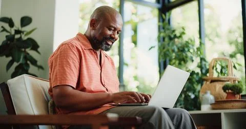 Remote work, typing or black man in house with laptop, lead update or edit .. Stock Photos