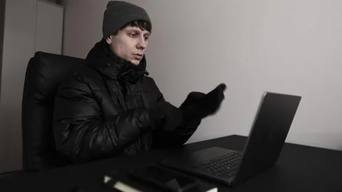 Remote work under crisis conditions, man putting on gloves and continuing work Stock Footage 329181885