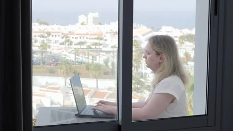 Remote Work with a View: Focused Woman Using Laptop on Balcony Stock Footage 317018789