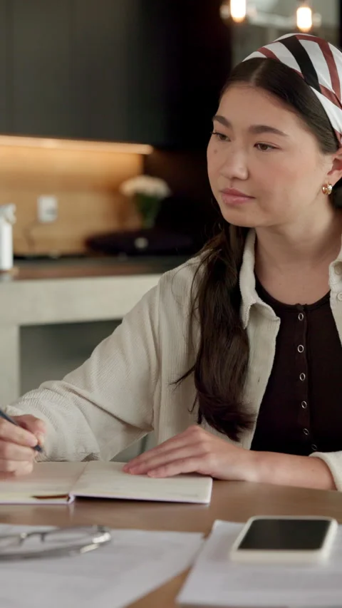 Remote work, writing and Asian woman with notebook in home, plot development and Stock Footage 336656015
