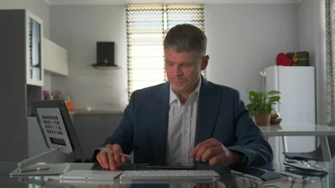 Remote worker in an apartment struggles with a frozen screen. Stock Footage 296219694