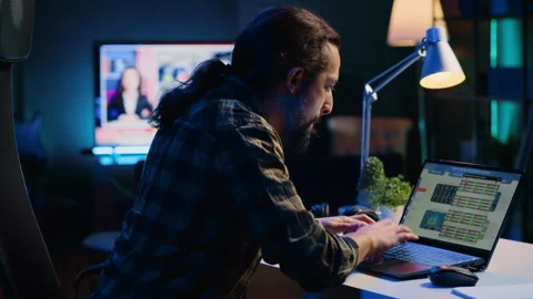 Remote worker comparing business graphic economic figures Stock Footage 263855542