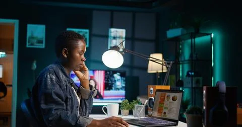 Remote worker crosschecking important info between clipboard and notebook Stock Photos