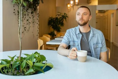 Remote worker enjoys coffee while studying online in modern workspace with .. Foto stock