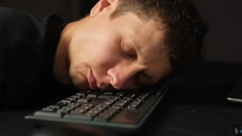 Remote worker exhausted falling asleep on keyboard home office burnout fatigue Stock Footage 318651927