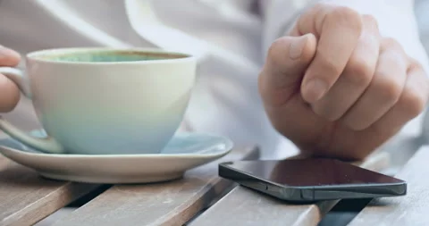 Remote worker with mug of coffee types messages to client Stockbeeldmateriaal 255208969