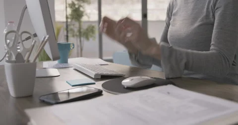 Remote worker sitting at desk and wearing a headset Stock Footage 154513597