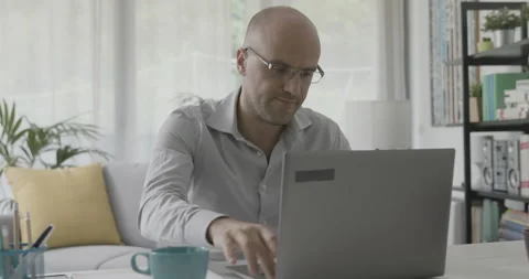 Remote worker sitting at desk and connecting with a laptop Stock Footage 162309454