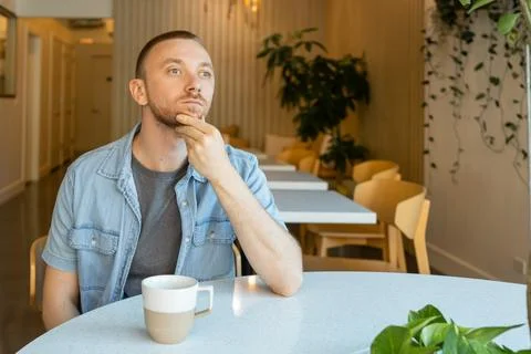 Remote worker thinking about online education opportunities while sitting i.. Stock Photos