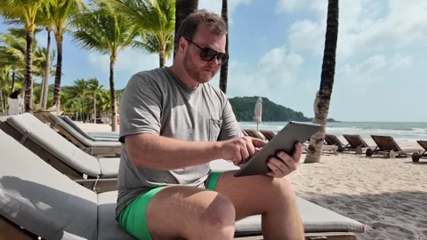Remote Worker on Tropical Beach with Tablet Stock Footage 263339411
