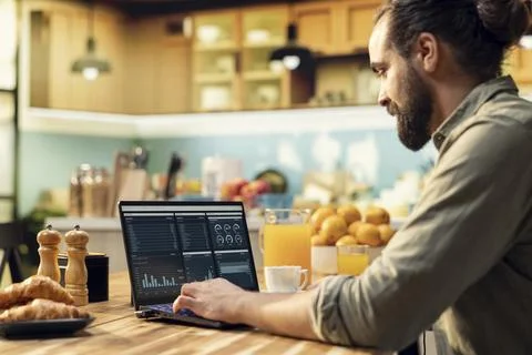 Remote worker using laptop and digital tools to analyze and research information 스톡 사진