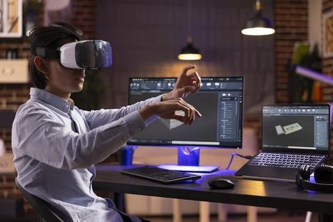 Remote worker wearing VR headset and designing mechanical prototypes 写真素材