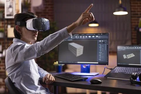 Remote worker wearing vr headset and working with cad tools on computers Foto stock