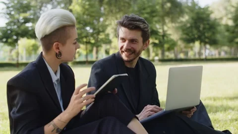 Remote workers meet in real life local park. Concept of young business people Stock Footage 254156671