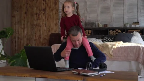 Remote working with kids during COVID-19 Lockdown. Stressed dad Works Stock Footage 149097927