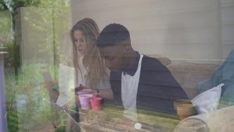 Remote working shot through window Creative Team talking Stock Footage 89922472