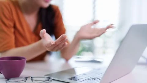 Remote working women using laptop computer hand gesture explaining business.. Stock Photos