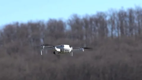 Remotely controlled drone with camera system in full operation Stock Footage 270535311