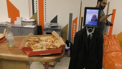 A remotely controlled humanoid robot on wheels mingling among people 스톡 동영상 100133416