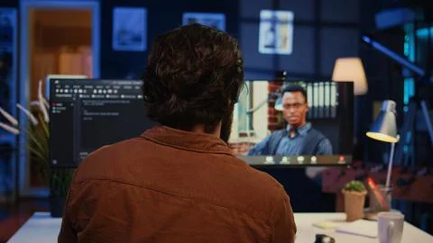 Remotely working software developer talking with manager during online videocall 스톡 사진