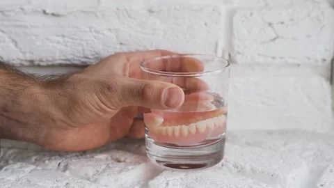 Removable jaw in a glass, close-up. Video stock 149646569